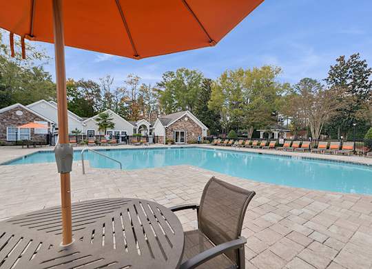 Community Swimming Pool with Pool Furniture at Lake Cameron Apartments located in Apex, NC.