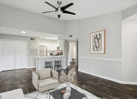 Model living room with view of kitchen