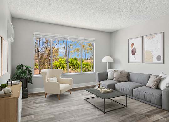 Model Living Room with Wood-Style Flooring and Window View at Fullerton Hills Apartments located in Fullerton, CA.