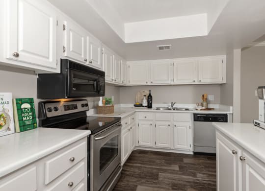 Model apartment kitchen with white cabinets and appliances at Saratoga Ridge, Phoenix, Arizona