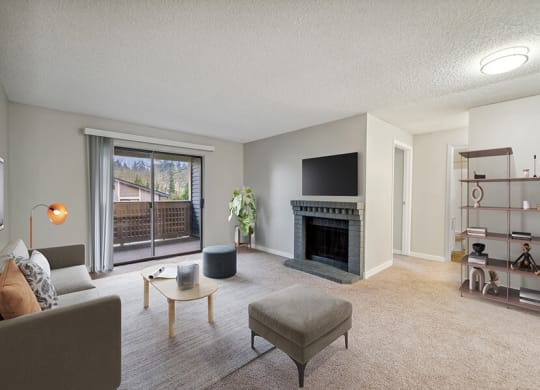 Model Living Room with Carpet, Fireplace and Patio Accessibility at Grammercy Apartments located in Renton, WA.