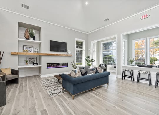 Community Clubhouse with Lounge Furniture and Fireplace at Bridges at Oakbend Apartments in Lewisville, TX.