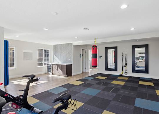 Community Fitness Center with Equipment at Los Gatos Landing Apartments located in San Jose, CA.