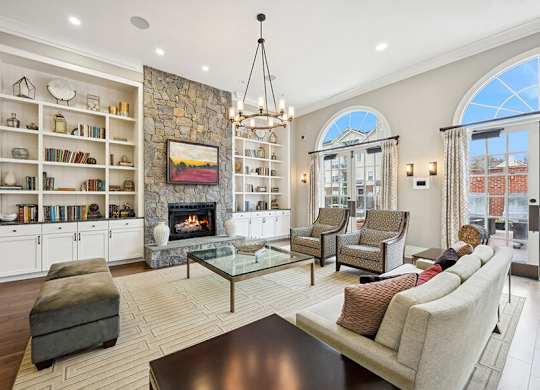 Community Clubhouse with Lounge Furniture and Fireplace at Dulles Green Apartments located in Herndon, VA.