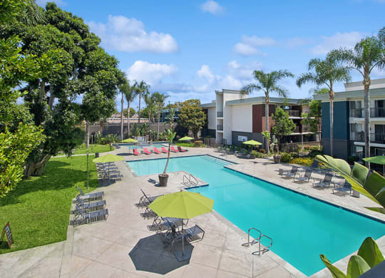 Aerial View of Community Swimming Pool with Pool Furniture at Madison Park Apartments located in Anaheim, CA.
