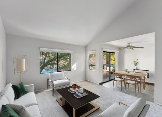 Model Living Room with Carpet and View of Dining Room at Creek at 2645 Apartments located in Sacramento, CA.