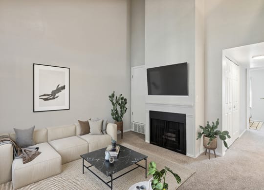Model Living Room with Carpet and Fireplace at Broadmoor Village Apartments in Salt Lake City, UT.