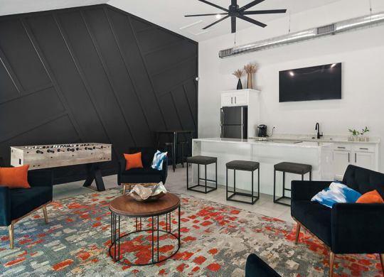 Community Clubhouse with Lounge Furniture, Game Tables & Kitchenette at Overlook Apartments located in Salt Lake City, UT.