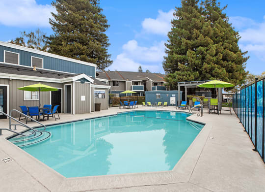 Community Swimming Pool with Pool Furniture at Meritage Apartments in Vallejo, CA.
