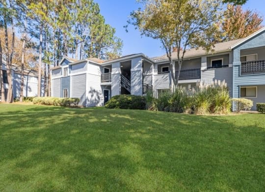 Apartment exterior showcasing landscaping and patios