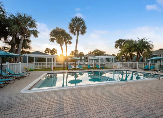 Community Swimming Pool with Pool Furniture at Park at 7200 Apartments in Jacksonville, FL.
