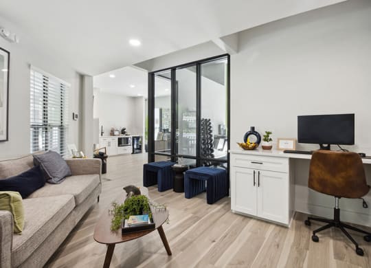 Community Clubhouse with Lounge Furniture and Work Stations at Arbor Village Apartments located in Charlotte, NC.
