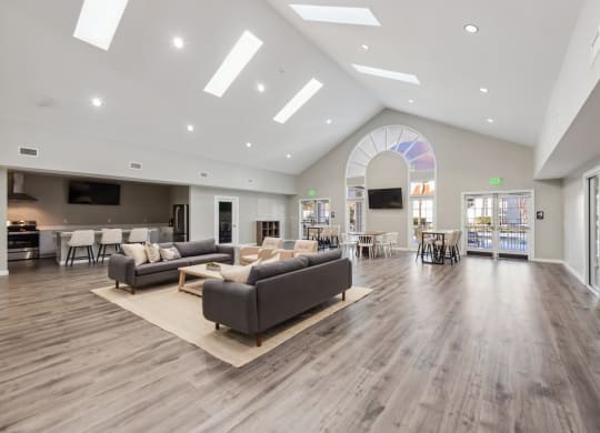 a large living room with couches and chairs and a large glass door