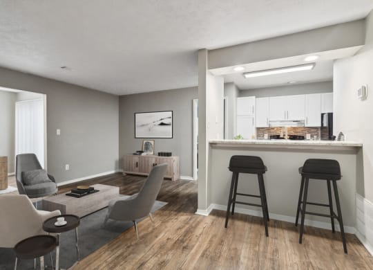 a living room with a bar and a kitchen