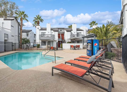 Community Swimming Pool with Pool Furniture at Crystal Creek Apartments in Phoenix, AZ.