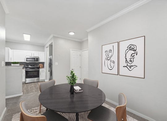 Model Dining Room with Carpet and View of Kitchen Area at Hidden Creek Apartments located in Lewisville, TX.