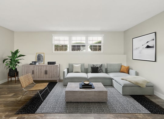 Model Living Room with Wood-Style Flooring at Meadows at Marlborough Apartments located in Marlborough, MA.