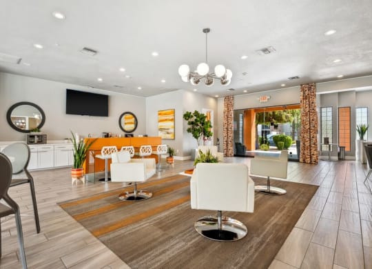 Community Clubhouse with Lounge Furniture and TV at Harmony at Surprise Apartments in Surprise, AZ.