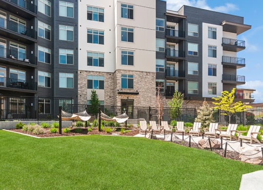 Outdoor Picnic Area with Lounge Furniture and View of Swimming Pool at Seven Skies Apartments located in Sandy, UT.