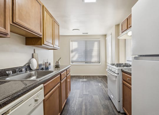 Model Kitchen with Oak Cabinets and Wood-Style Flooring at Spring Parc Apartments in Silver Spring, MD.