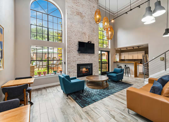 Community Clubhouse with Lounge Furniture and Kitchenette Area at Dallas North Park Apartments in Dallas, TX.