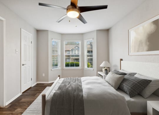a bedroom with a large bed and a ceiling fan