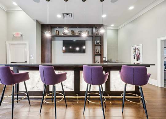 Community Clubhouse Kitchenette Area with TV at Dulles Green Apartments located in Herndon, VA.