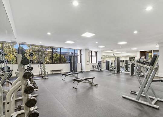 Community Fitness Center with Equipment at Madison Park Apartments located in Anaheim, CA.