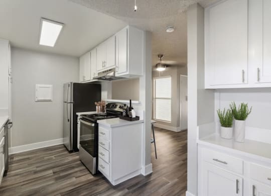 Model kitchen with white cabinetry