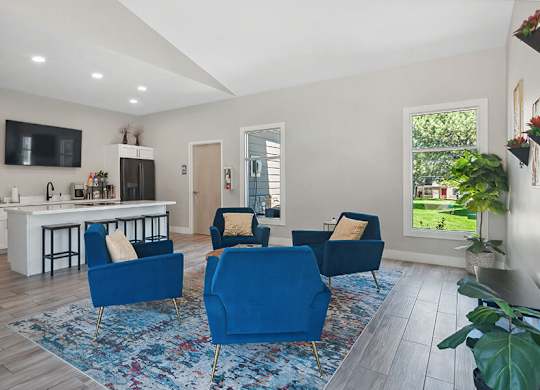 Community Clubhouse with Lounge Furniture and Kitchenette Area at Broadmoor Village Apartments located in West Jordan, UT.