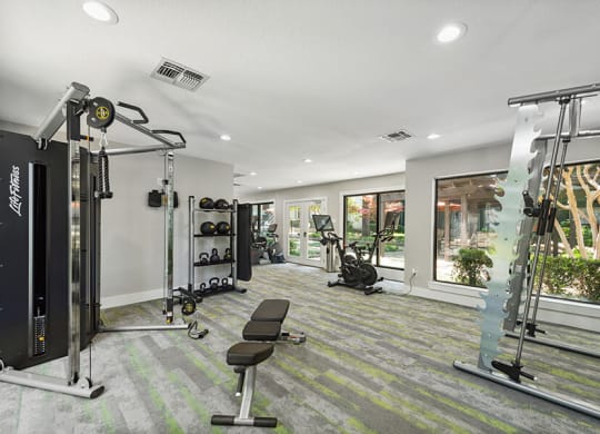 Community Fitness Center with Equipment at Bridges at Deer Run Apartments in Dallas, TX.