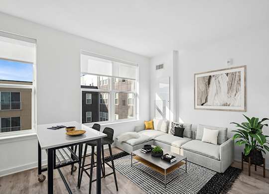 Model Living Room with Wood-Style Flooring and Window View at Stella Apartments located in New Carrollton, MD.