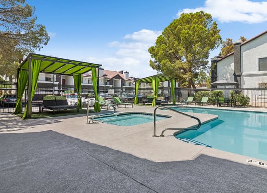 Community Swimming Pool with Pool Furniture at Meadow Ridge Apartments located in Las Vegas, NV.