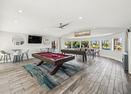 Community Clubhouse with Game Tables and Lounge Furniture at Stonegate Apartments located in Las Vegas, NV.
