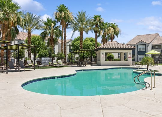 Community Swimming Pool with Pool Furniture at Monterra Apartments located in Las Vegas, NV.