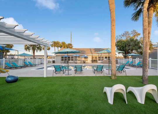 Community Swimming Pool with Pool Furniture at Park at 7200 Apartments in Jacksonville, FL.