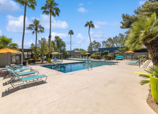 Community Swimming Pool with Pool Furniture at Lakeside Casitas Apartments in Tucson, AZ.