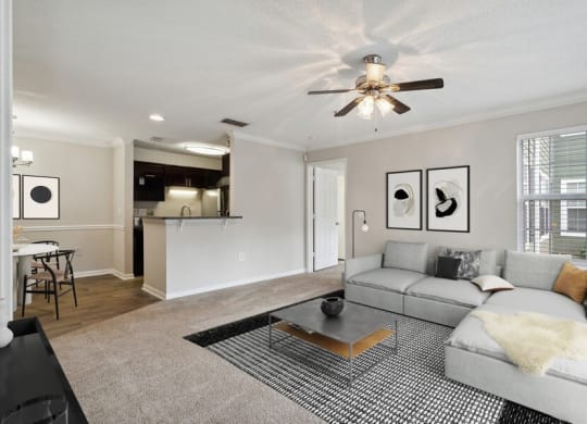 Model living room with view of kitchen