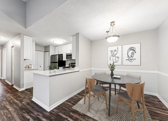 Model Dining Room with Wood-Style Flooring and View of Kitchen at Commons at Haynes Farm Apartments in Shrewsbury, MA.