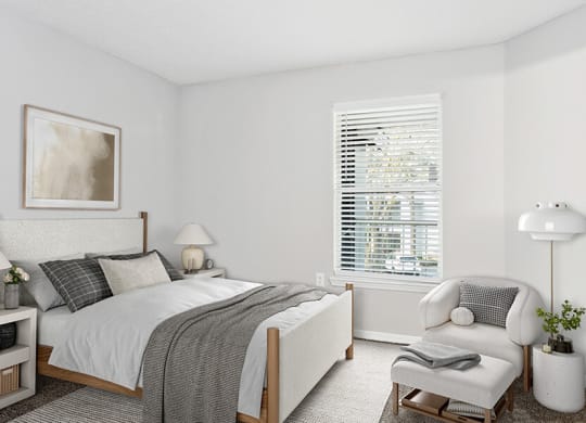 Model Bedroom with Carpet and Window View at Retreat at Crosstown Apartments in Riverview, FL.