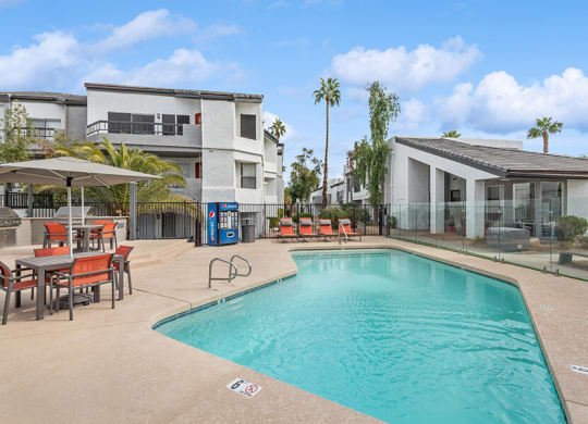 Community Swimming Pool with Pool Furniture at Crystal Creek Apartments in Phoenix, AZ.