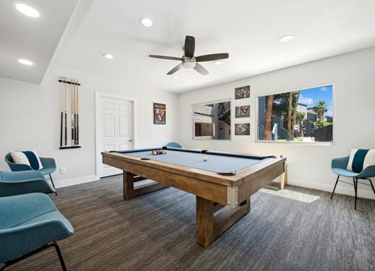 Community Clubhouse with Game Tables and Lounge Furniture at Country Club Verandas Apartments located in Mesa, AZ.