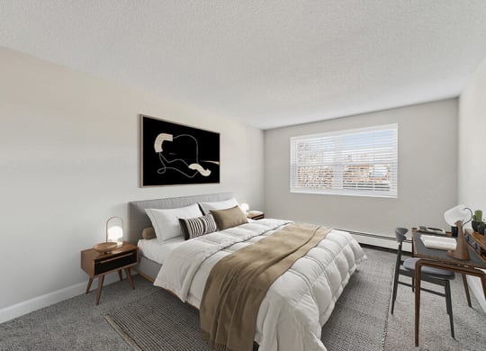 Model Bedroom with Carpet and Window View at Middlesex Crossing Apartments in Billerica, MA.