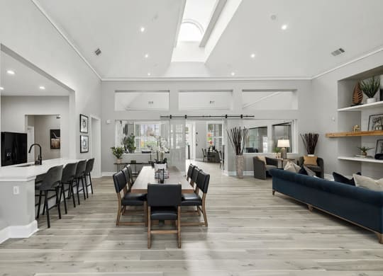 Community Clubhouse with Lounge Furniture and Kitchenette Area at Bridges at Oakbend Apartments in Lewisville, TX.