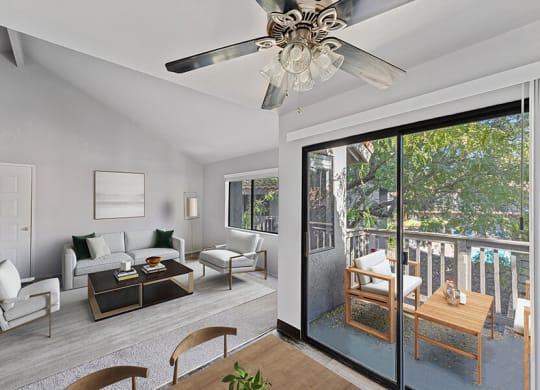 Model Living Room with Wood-Style Flooring and Patio Accessibility at Creek at 2645 Apartments located in Sacramento, CA.
