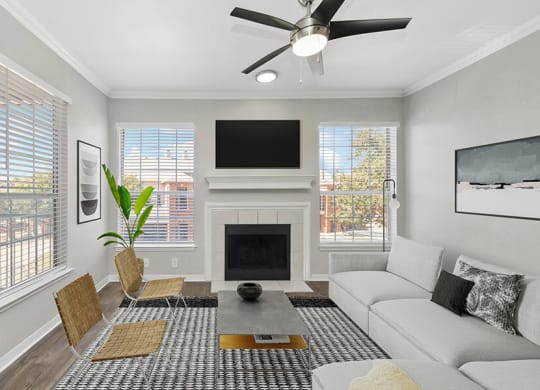 Model Living Room with Wood-Style Flooring and Fireplace at Chapel Hill Apartments in Lewisville, TX.
