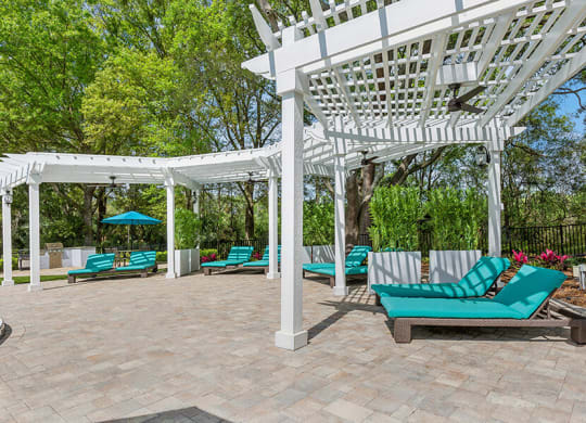 Community Patio with Pool Furniture at Grand Pavilion Apartments in Tampa, FL.
