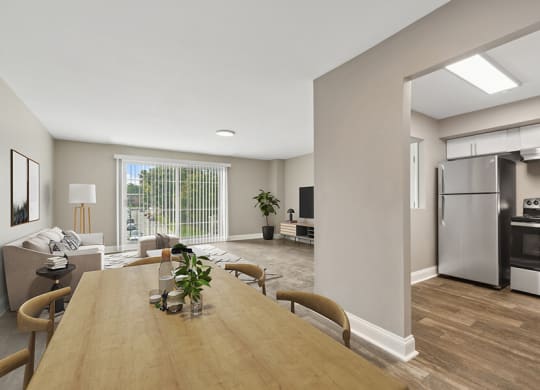 Model Dining Room with Wood-Style Flooring and View of Kitchen at Heights at Marlborough Apartments located in Marlborough, MA.