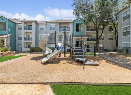 Community Playground with a Slide at Essence Apartments in Dallas, TX.