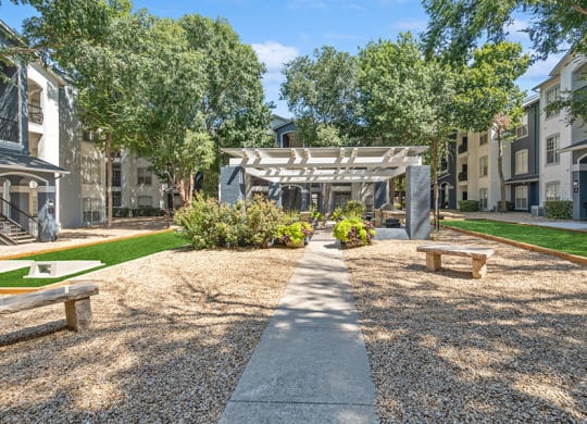 Community Courtyard with Benches at Allure North Dallas Apartments in Dallas, TX.